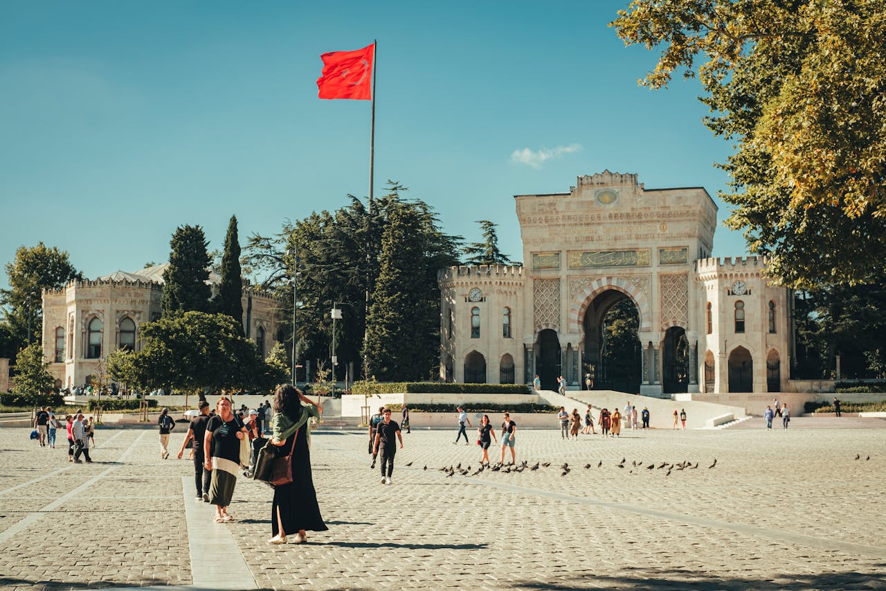 People in Front of Istanbul University Gate with Flag